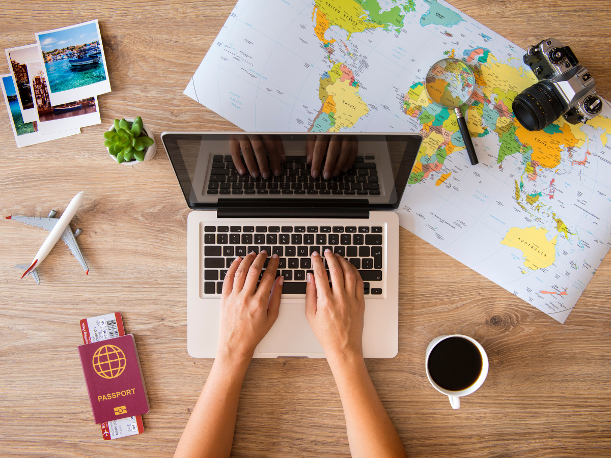 Flat lay of hands holding a coffee mug on a workspace—symbolizing calm, intentional planning.